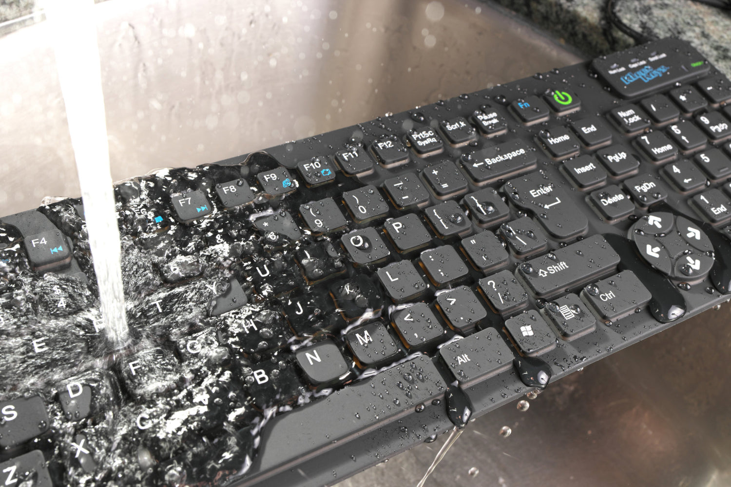 Water pouring on to a Kleen Keys computer keyboard